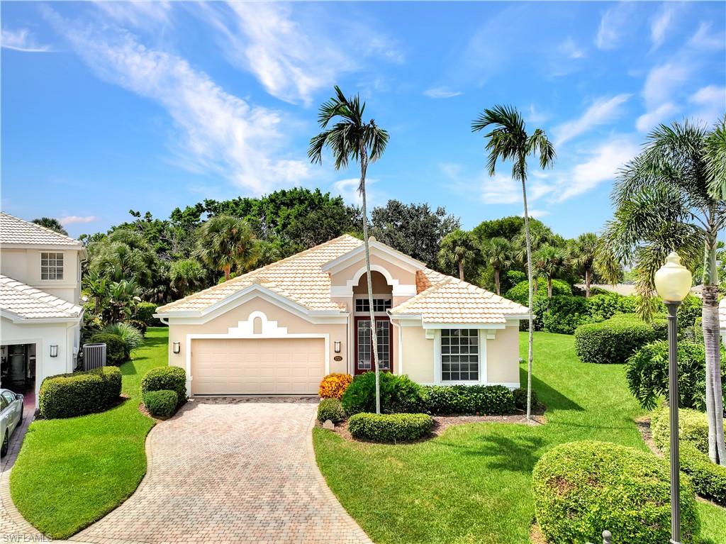 1721 Marsh Run Naples, FL 34109 - Photo 7 of 35 a front view of a house with a yard and garage