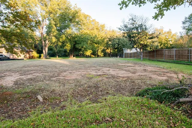 a view of dirt yard with a trees