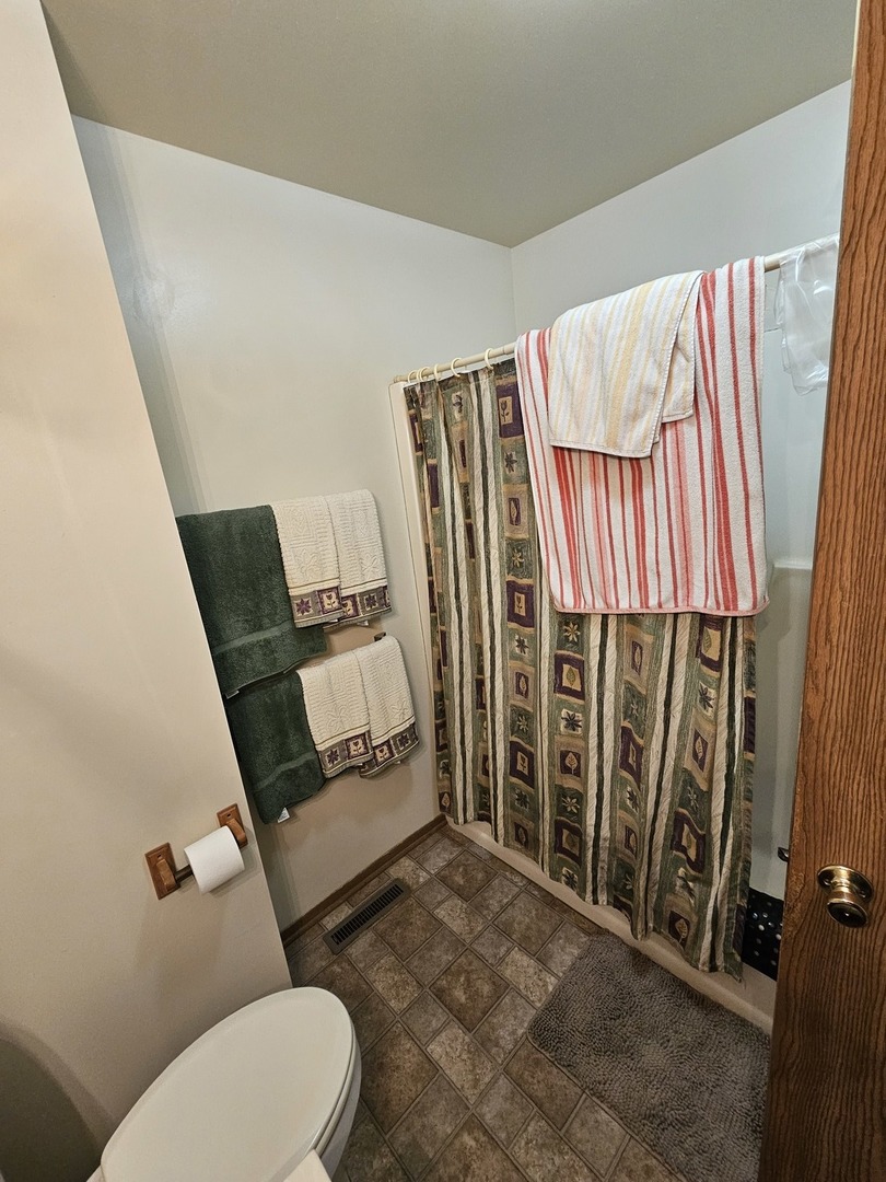 847-849 Rhodes Street Woodstock, IL 60098 - Photo 24 of 44 a bathroom with a toilet and a shower