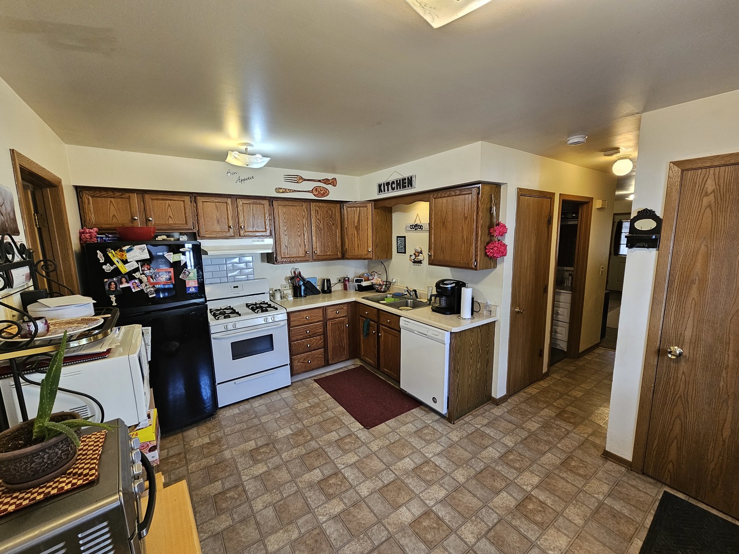 847-849 Rhodes Street Woodstock, IL 60098 - Photo 35 of 44 a kitchen with a refrigerator and a stove top oven