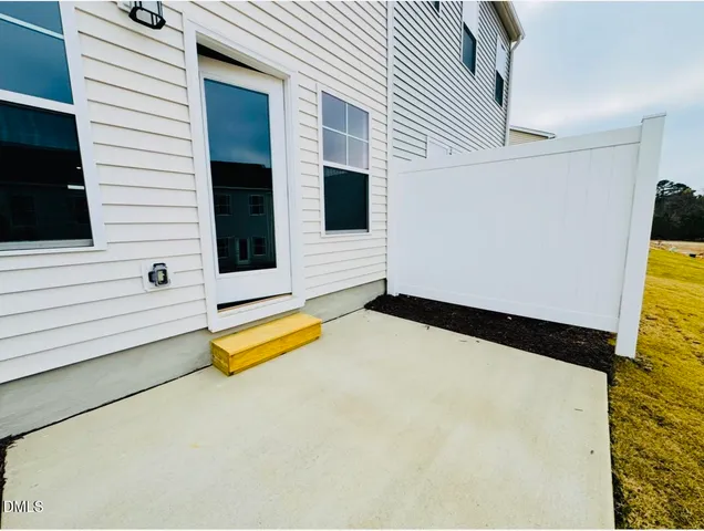 a kitchen with white cabinets and sink