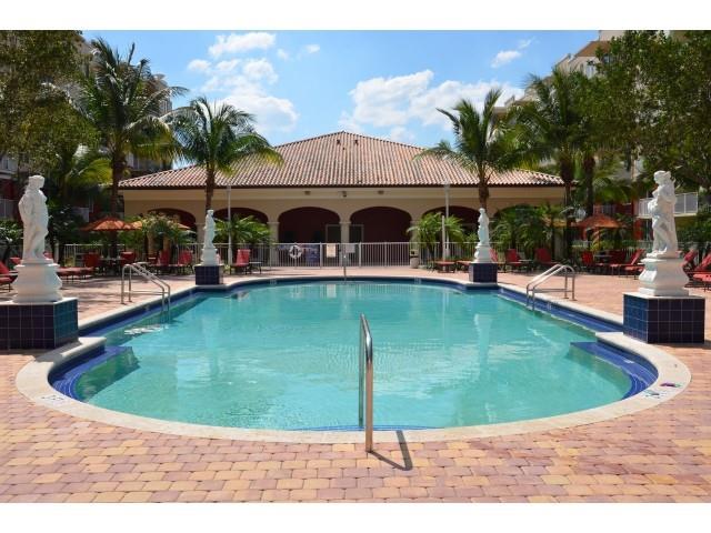 18335 Northwest 68th Avenue, Unit 245208 Hialeah, FL 33015 - Photo 16 of 18 a view of a swimming pool with a bench in front of it
