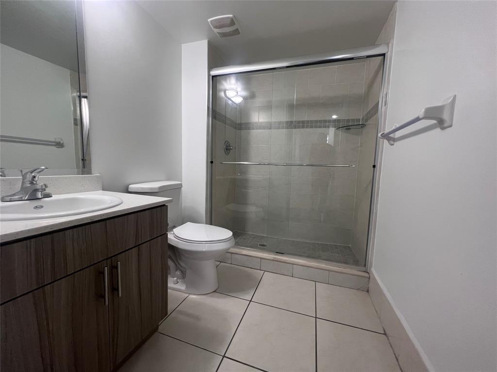 18335 Northwest 68th Avenue, Unit 245208 Hialeah, FL 33015 - Photo 8 of 18 a bathroom with a sink a toilet and shower