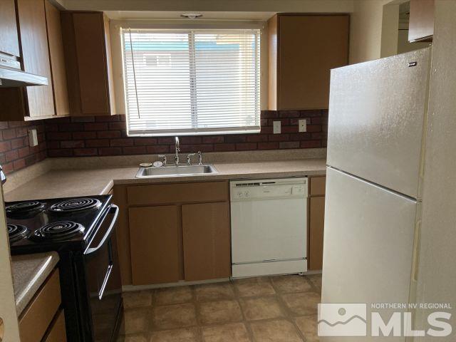 3240 Gypsum Road Reno, NV 89503 - Photo 12 of 14 a kitchen with a stove a refrigerator and a sink