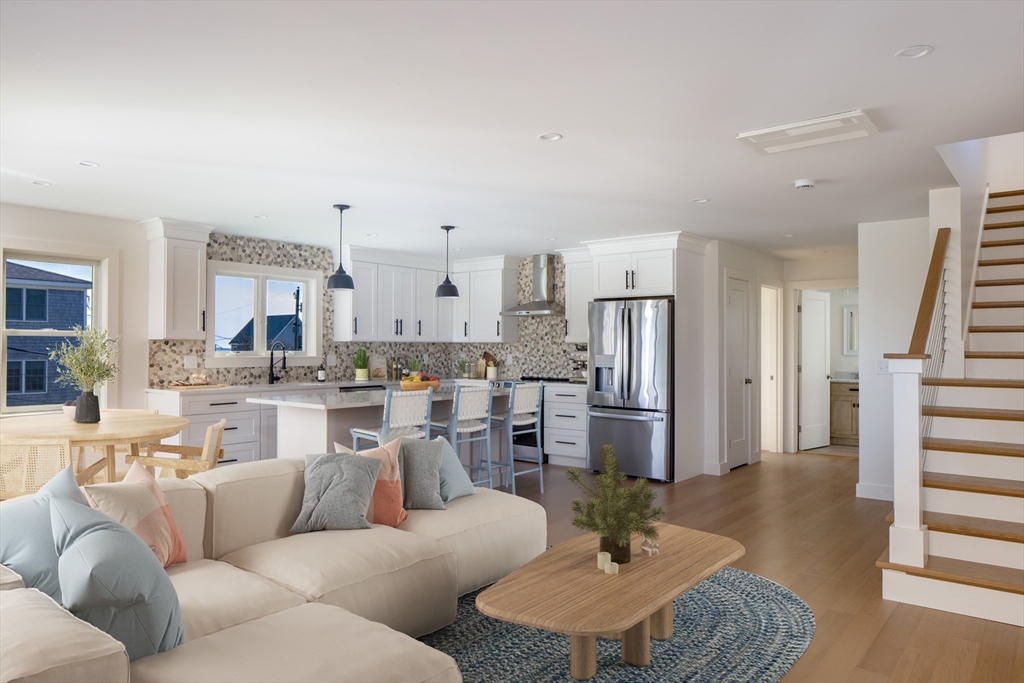 8 Channel Street Mattapoisett, MA 02739 - Photo 11 of 39 a living room with furniture kitchen view and a wooden floor