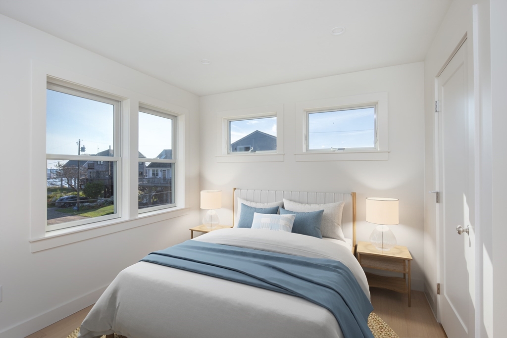 8 Channel Street Mattapoisett, MA 02739 - Photo 14 of 39 a bedroom with a bed and a large window