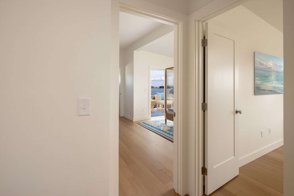 8 Channel Street Mattapoisett, MA 02739 - Photo 16 of 39 a view of a hallway with wooden floor and a bathroom