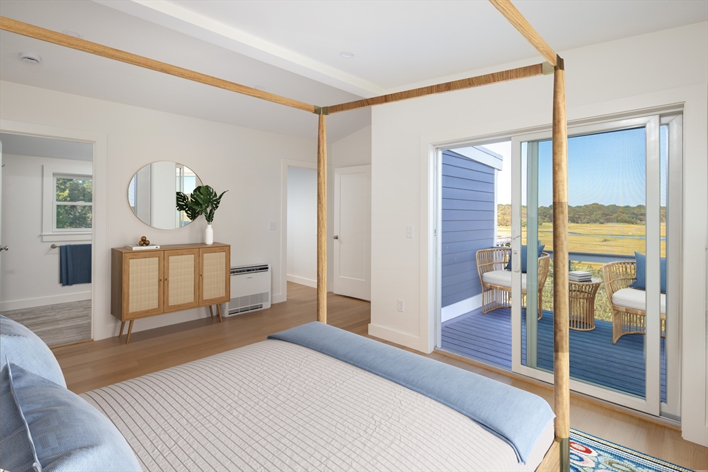 8 Channel Street Mattapoisett, MA 02739 - Photo 17 of 39 a bedroom with a bed and large windows with outer view