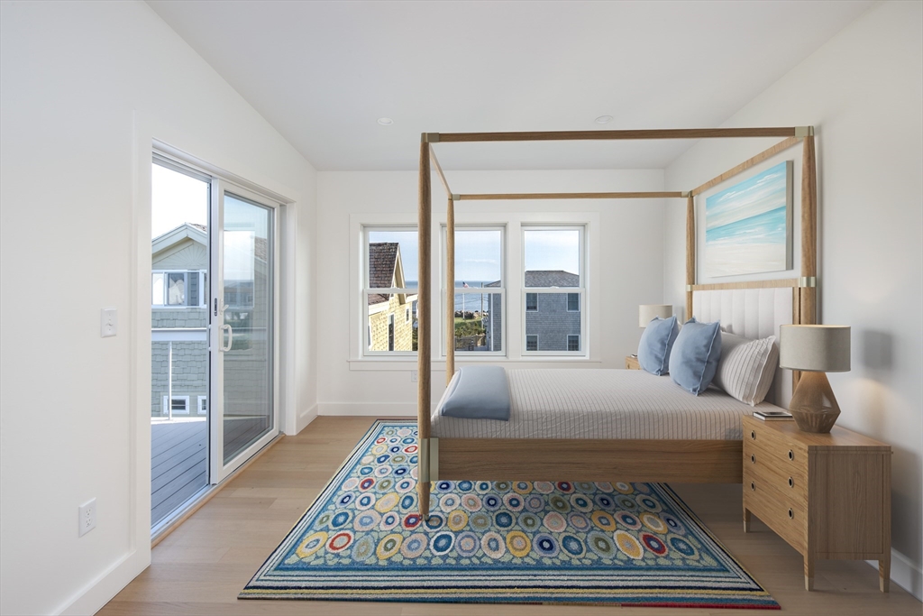 8 Channel Street Mattapoisett, MA 02739 - Photo 19 of 39 a bedroom with a bed and wooden floor