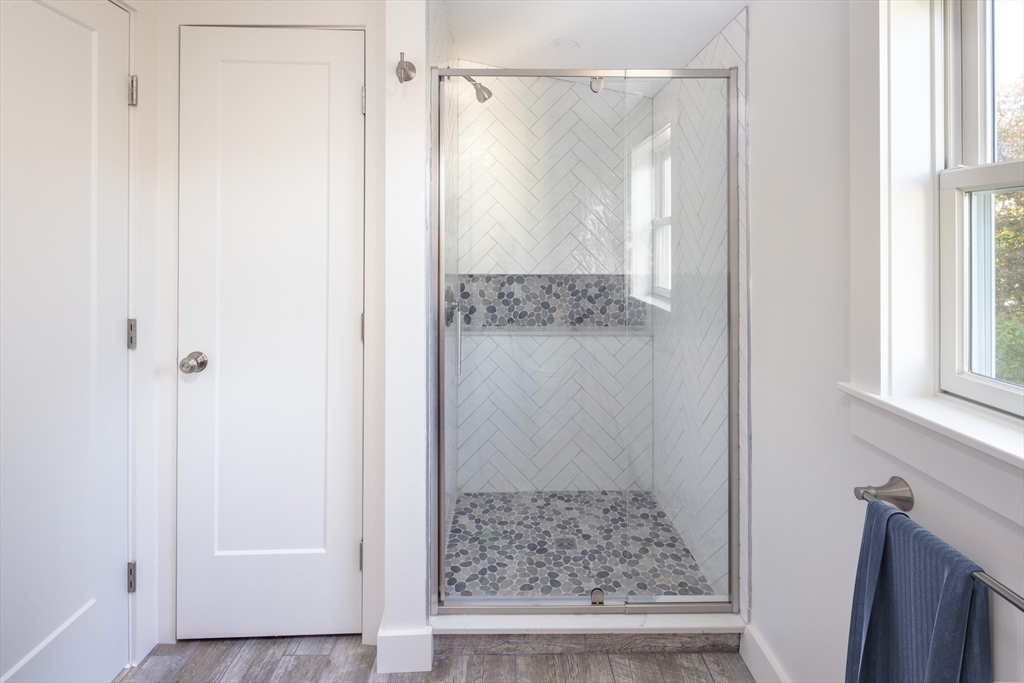 8 Channel Street Mattapoisett, MA 02739 - Photo 21 of 39 a bathroom with a glass shower door