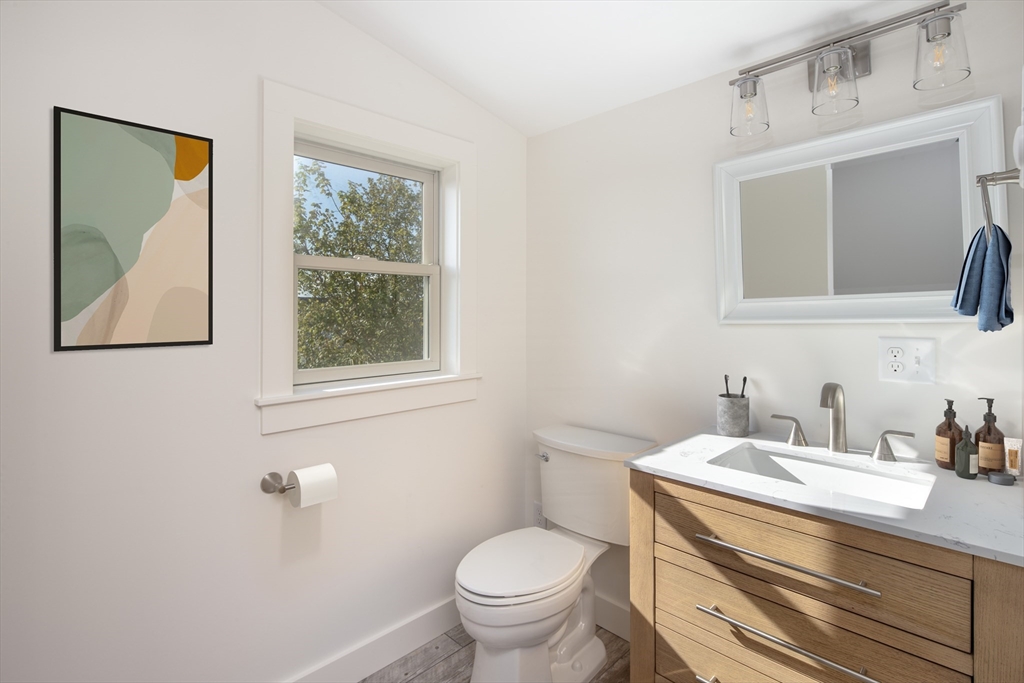8 Channel Street Mattapoisett, MA 02739 - Photo 25 of 39 a bathroom with a toilet a sink a vanity and mirror
