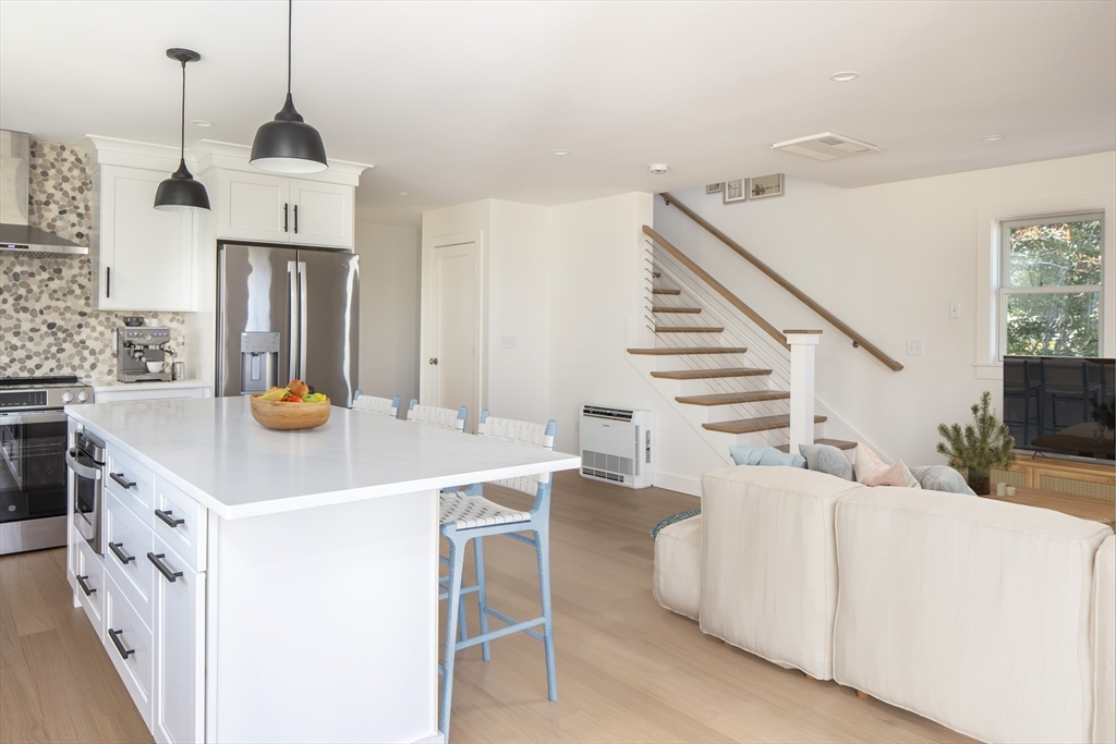 8 Channel Street Mattapoisett, MA 02739 - Photo 7 of 39 a kitchen with stainless steel appliances and white cabinets
