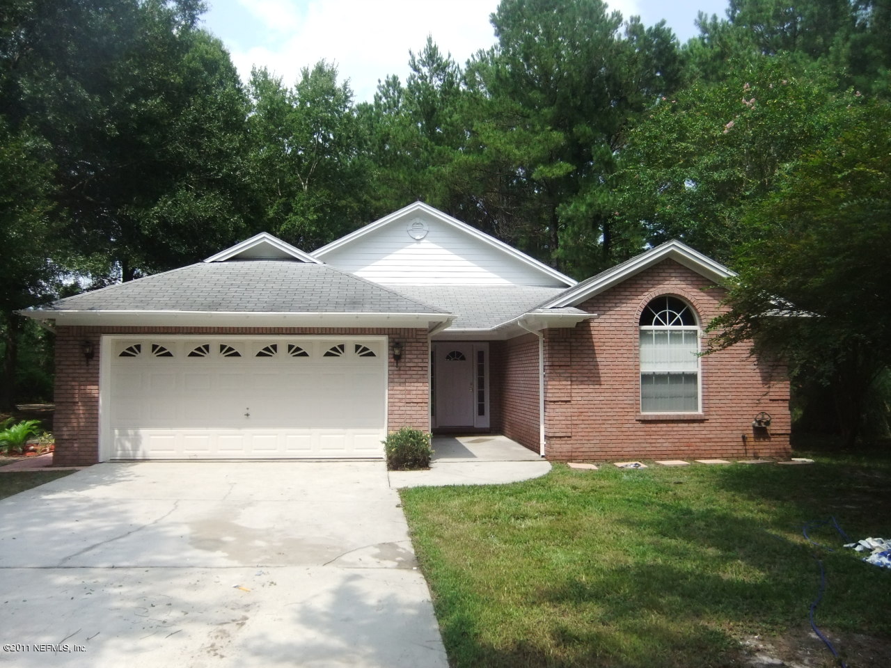 56101 Griffin Road Callahan, FL 32011 - Photo 1 of 18 a front view of a house with garden