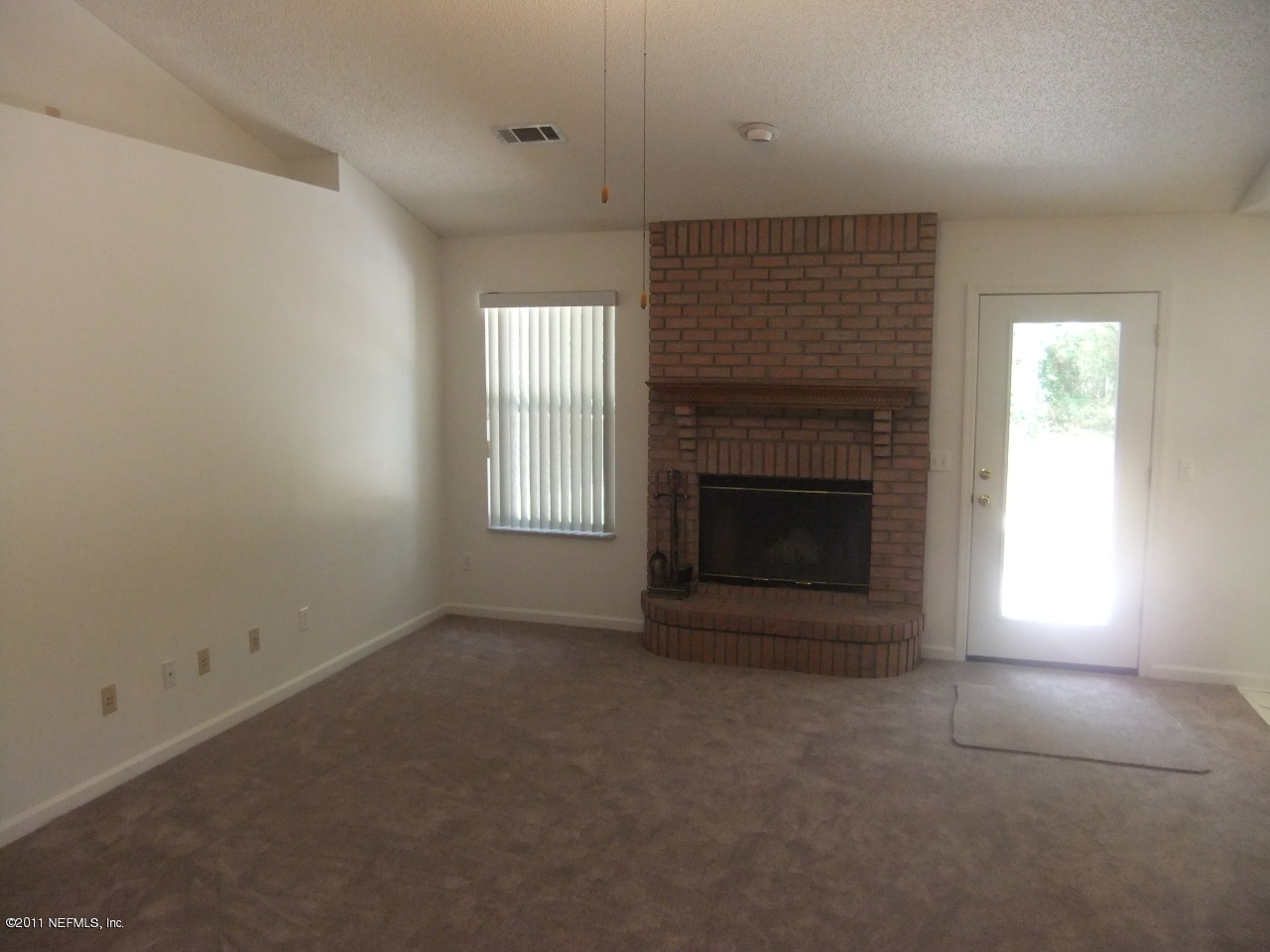 56101 Griffin Road Callahan, FL 32011 - Photo 11 of 18 an empty room with a fireplace
