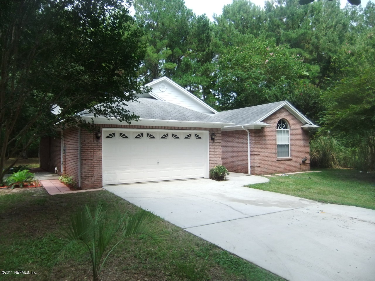 56101 Griffin Road Callahan, FL 32011 - Photo 2 of 18 a front view of a house with a yard and garage