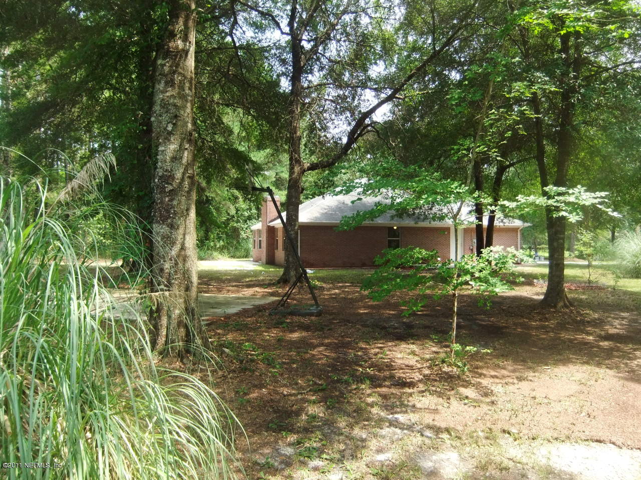 56101 Griffin Road Callahan, FL 32011 - Photo 7 of 18 a view of a yard with plants and a large tree