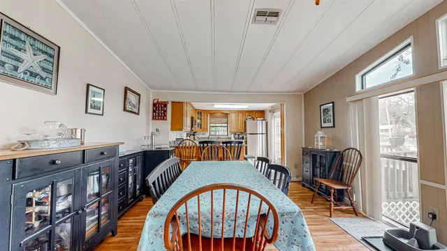 a living room with furniture two window and a dining table