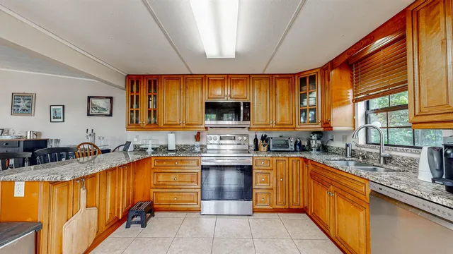 a kitchen with lots of counter top space sink and stainless steel appliances