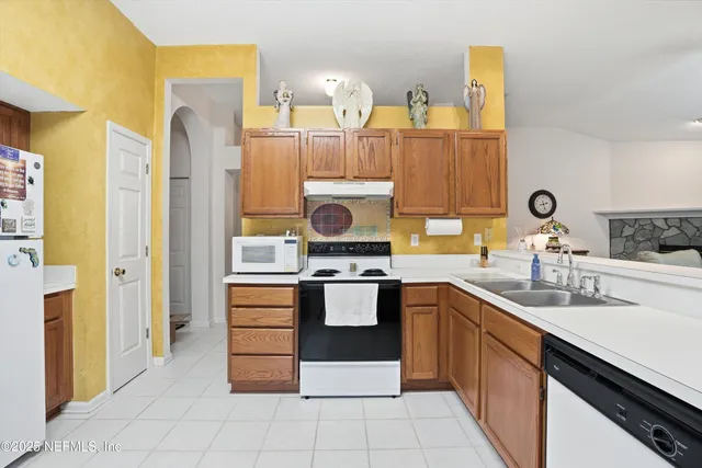 a kitchen with stainless steel appliances granite countertop a sink and cabinets
