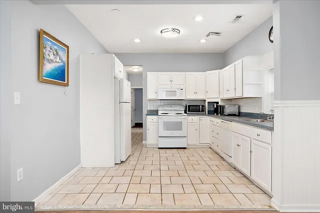 a kitchen with stainless steel appliances a refrigerator sink and cabinets