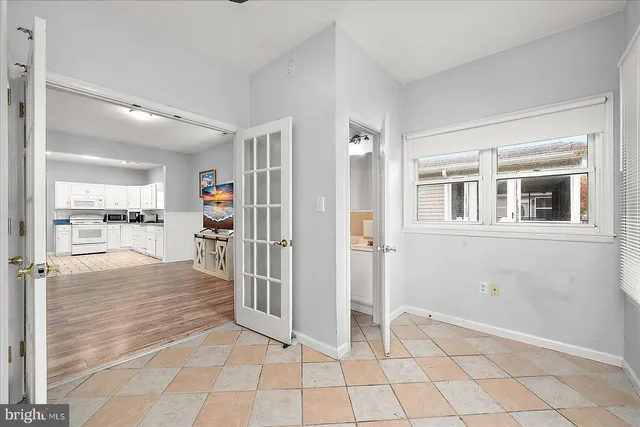 a view of a livingroom with kitchen and furniture