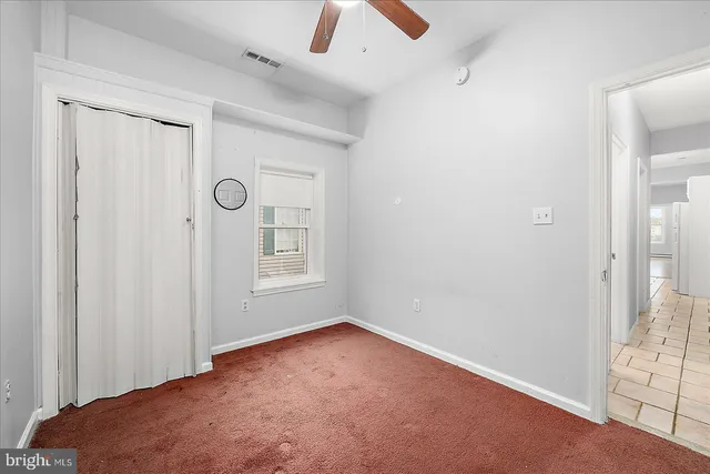 an empty room with windows and closet