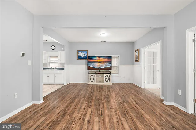 a bedroom with a bed and a view of kitchen