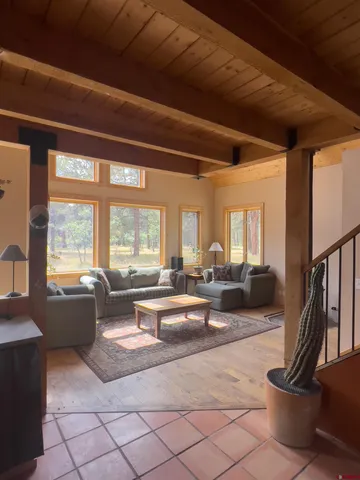 a living room with furniture large window and a table