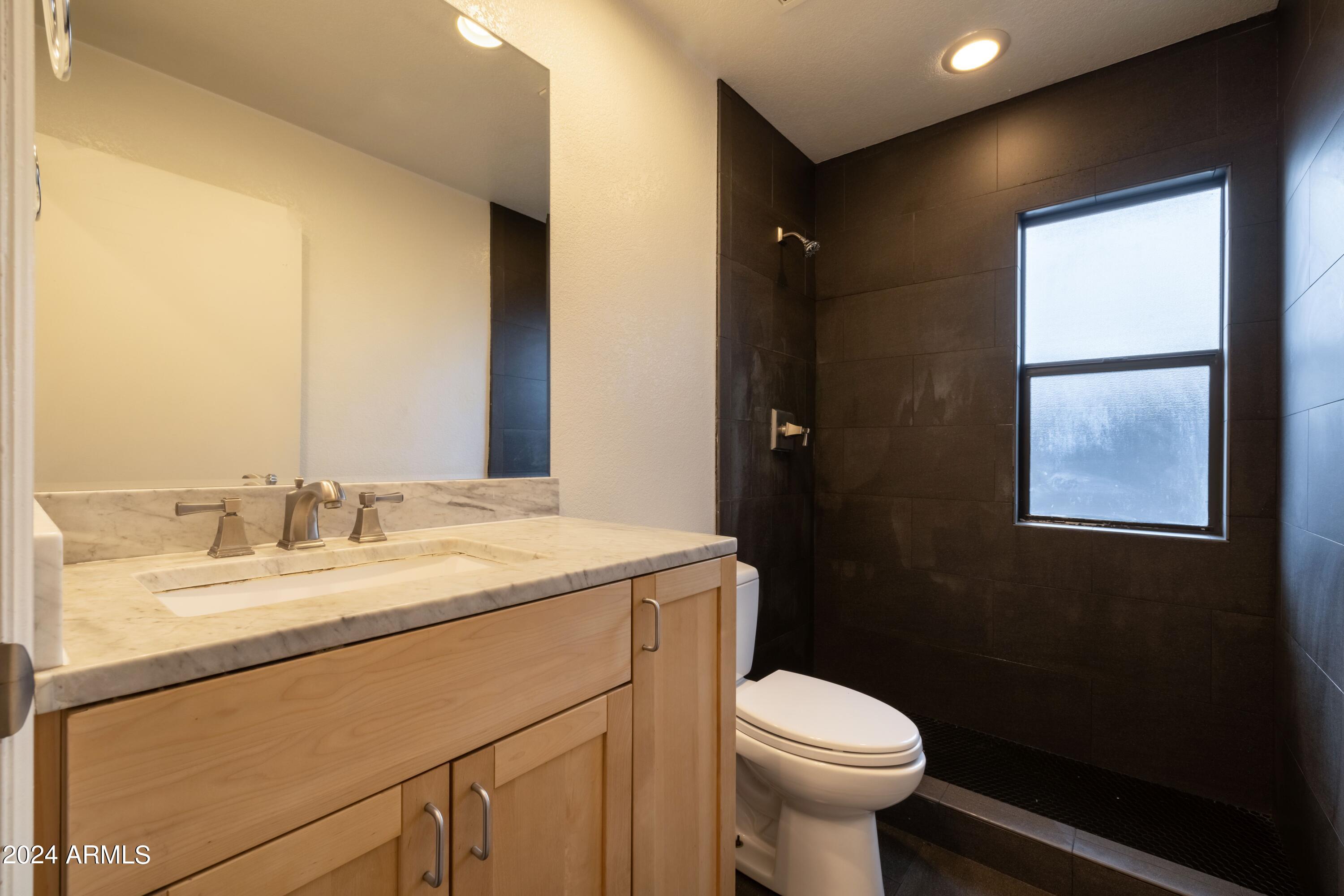 3034 North 35th Street Phoenix, AZ 85018 - Photo 20 of 37 a bathroom with a sink and a toilet