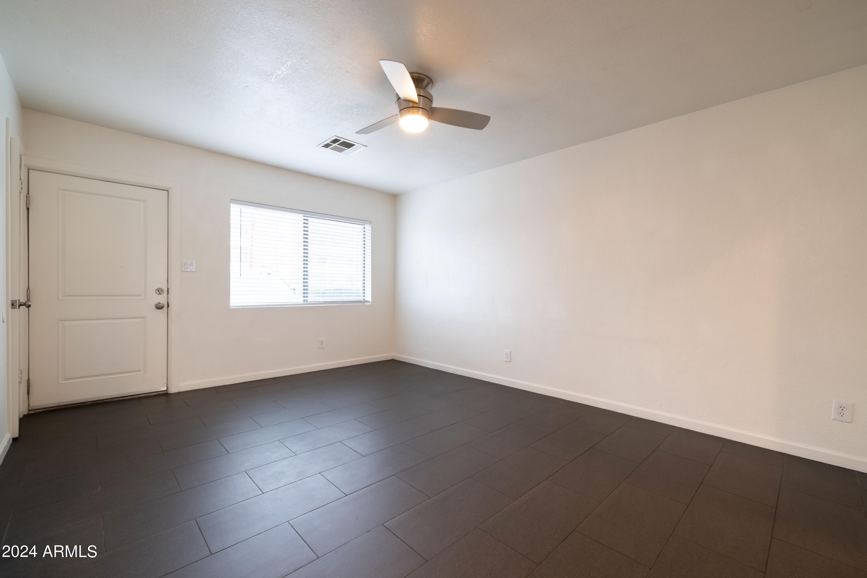 3034 North 35th Street Phoenix, AZ 85018 - Photo 23 of 37 an empty room with a ceiling fan and window