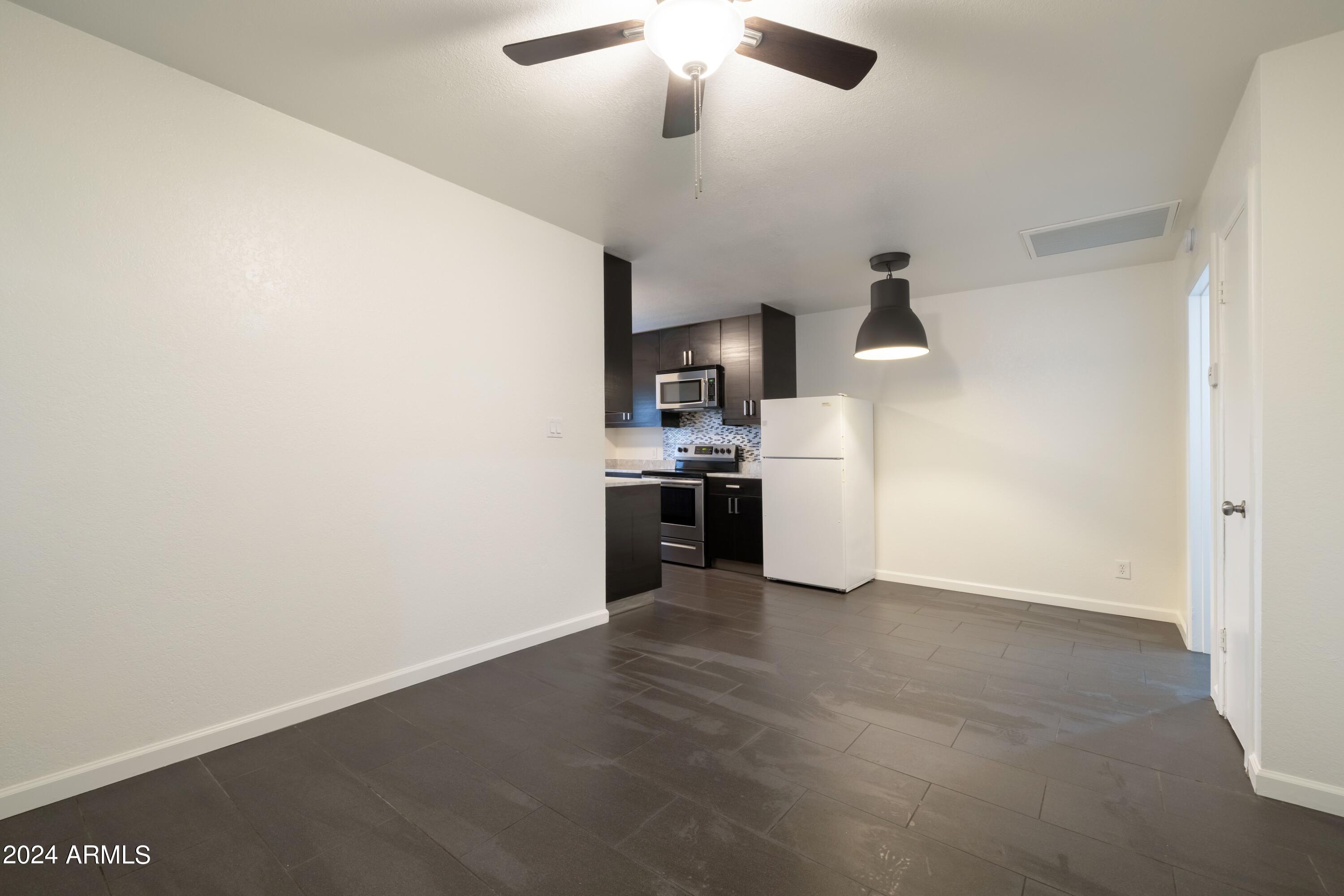 3034 North 35th Street Phoenix, AZ 85018 - Photo 27 of 37 a view of a kitchen with a microwave and a stove