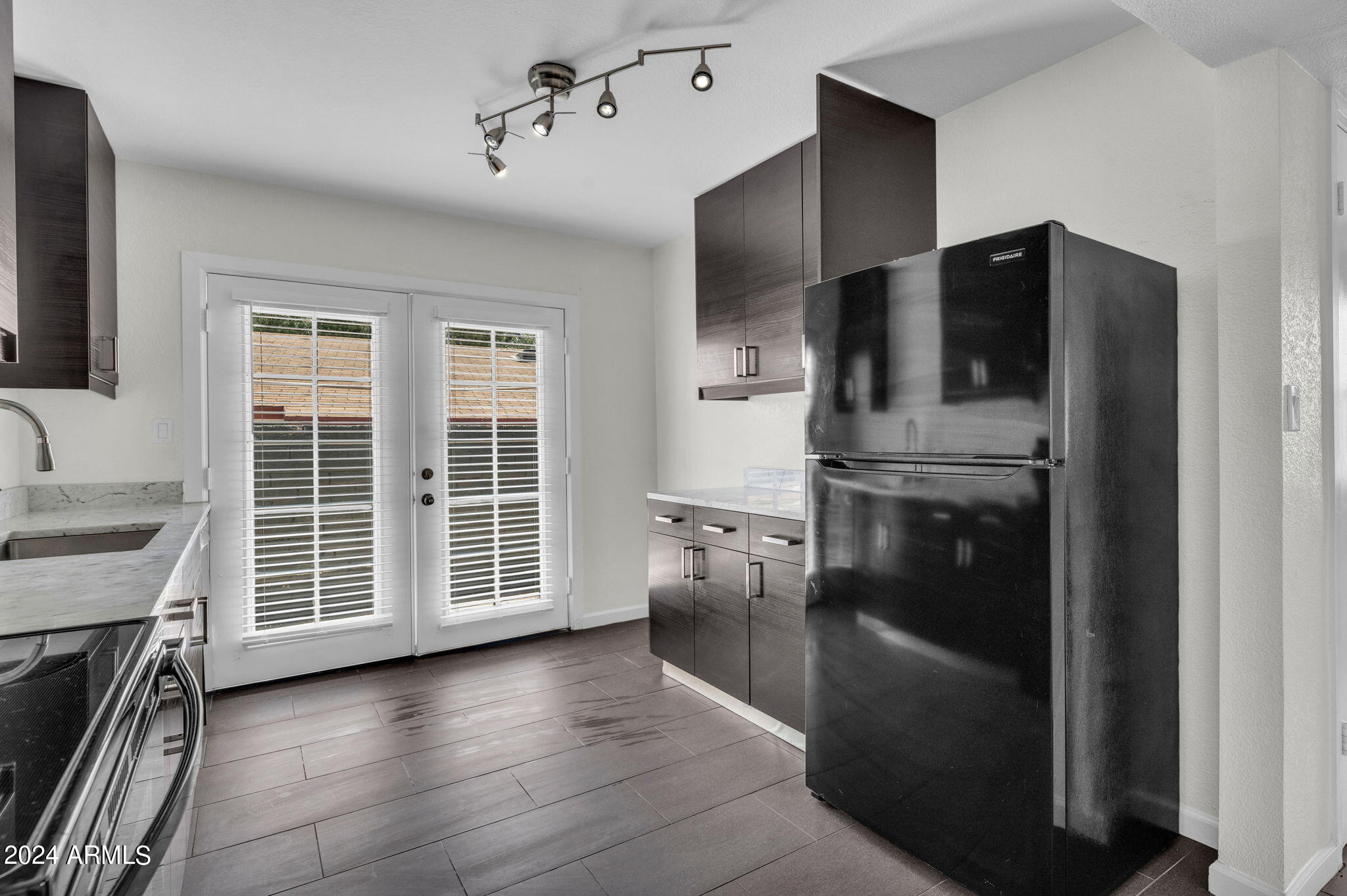 3034 North 35th Street Phoenix, AZ 85018 - Photo 4 of 37 a kitchen with a refrigerator and a sink