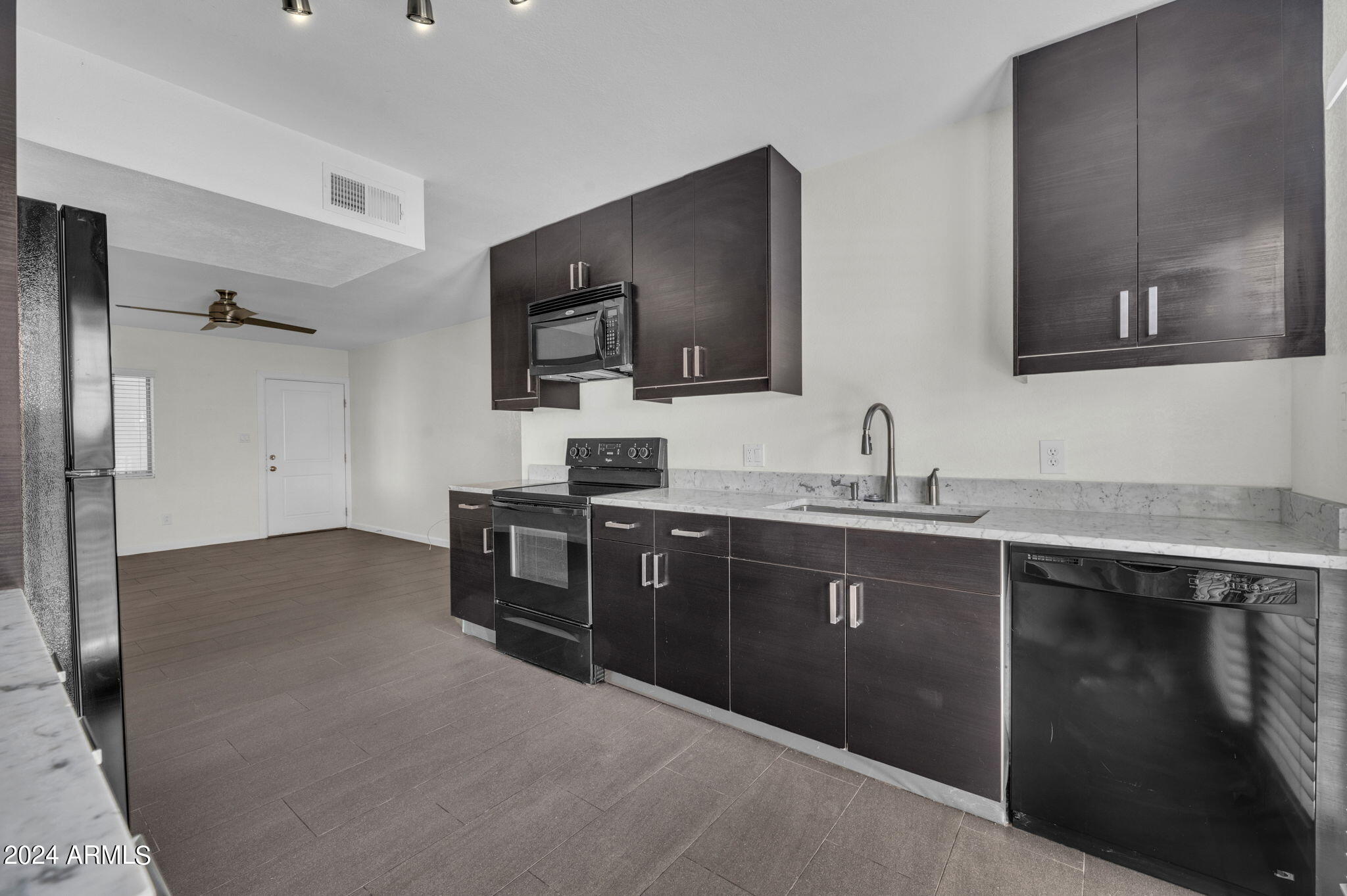 3034 North 35th Street Phoenix, AZ 85018 - Photo 5 of 37 a kitchen with stainless steel appliances granite countertop a sink stove and refrigerator