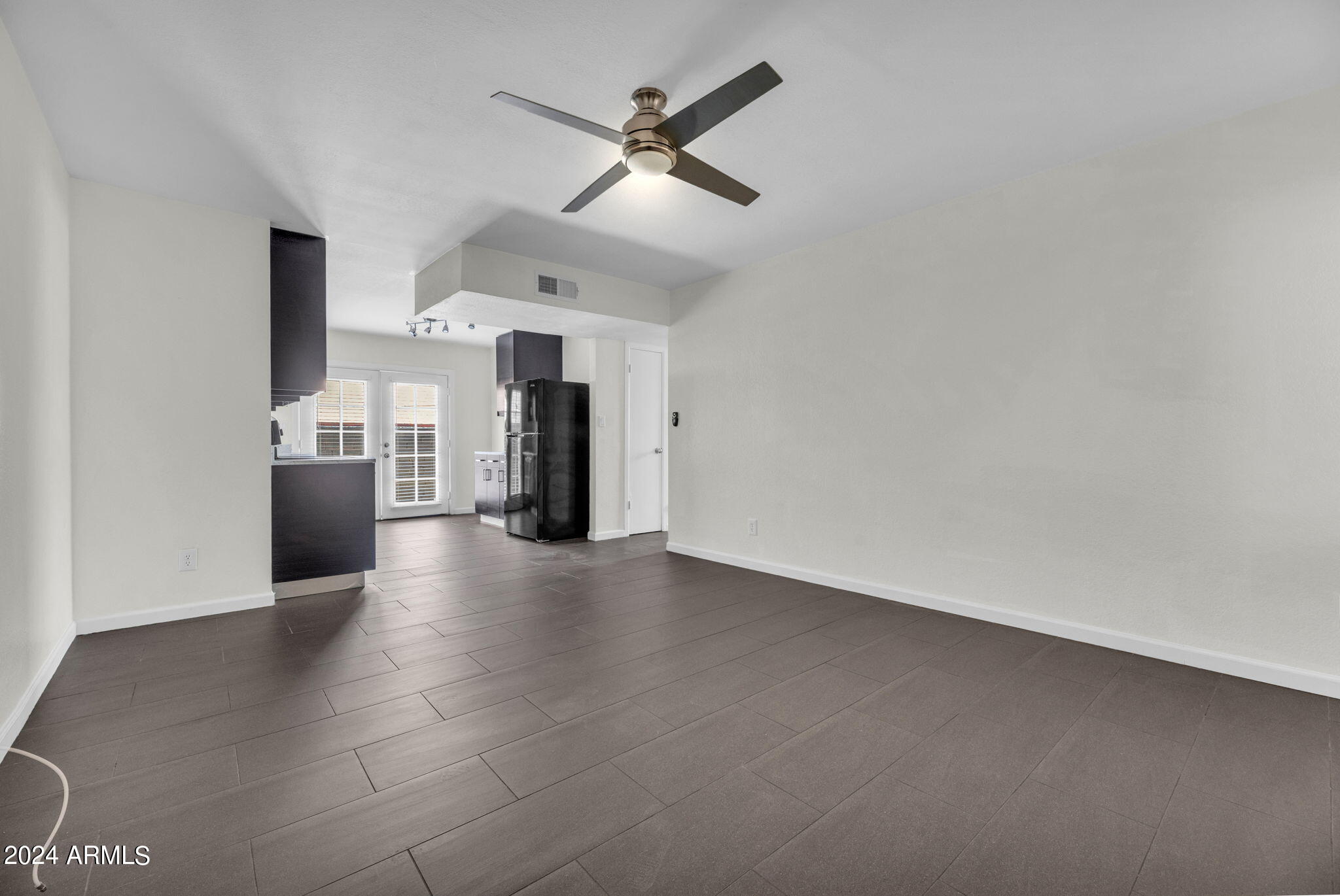 3034 North 35th Street Phoenix, AZ 85018 - Photo 8 of 37 an empty room with staircase and white walls