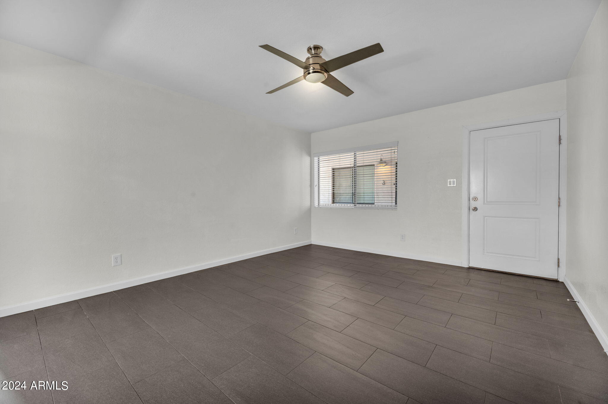 3034 North 35th Street Phoenix, AZ 85018 - Photo 9 of 37 an empty room with a ceiling fan and windows