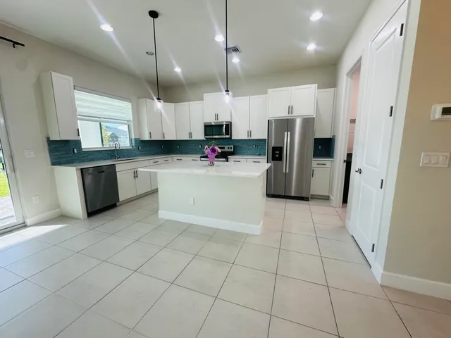 a kitchen with refrigerator and microwave