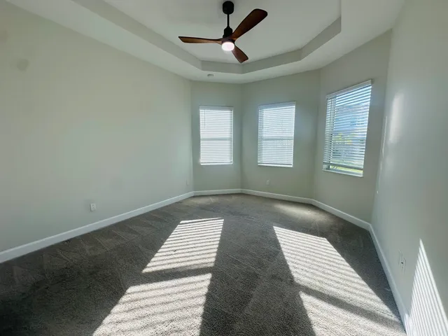 a view of wooden floor and windows in a room