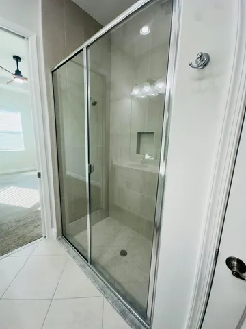 a bathroom with a glass shower door