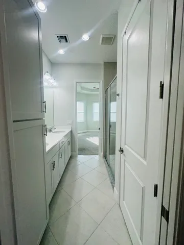a bathroom with a double vanity sink and mirror
