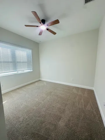 an empty room with a empty space and windows