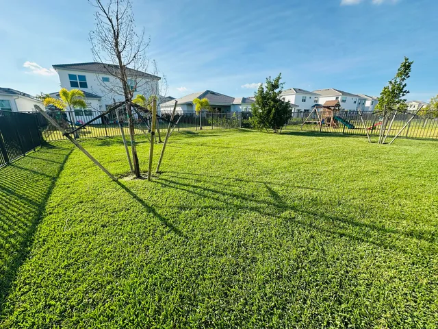 an aerial view of a house with a yard and lake view