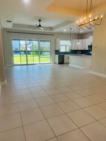 a view of a kitchen with a sink and a large window