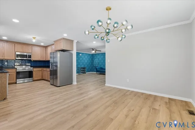 a kitchen with kitchen island a counter top space a sink cabinets and stainless steel appliances