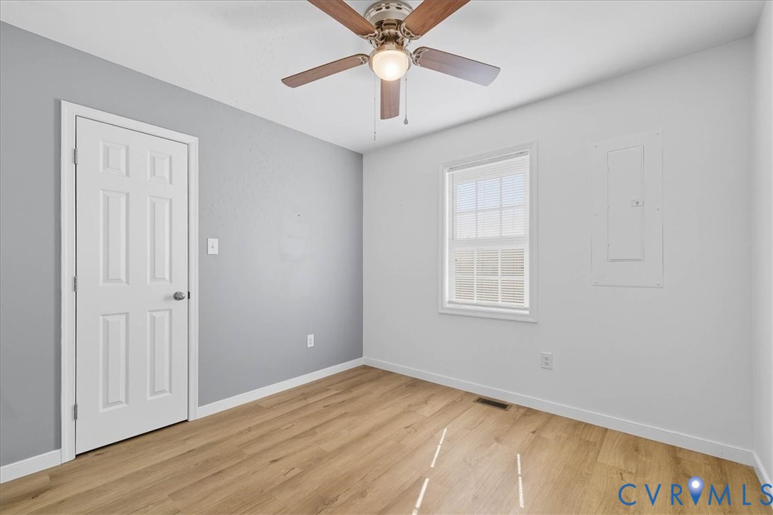 1005 West Main Street Waverly, VA 23890 - Photo 21 of 32 wooden floor in an empty room with a window