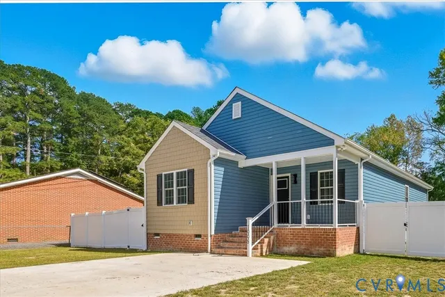 a view of a house with a yard and large tree