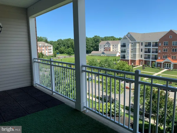 a view of a balcony with yard from a balcony