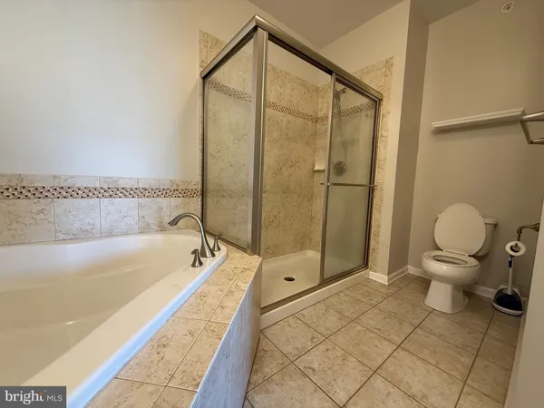 a bathroom with a bathtub and toilet