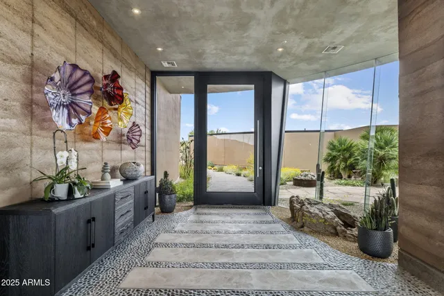 a spacious bedroom with a large bed a couch and a potted plant