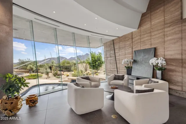 a living room with patio furniture and a potted plant