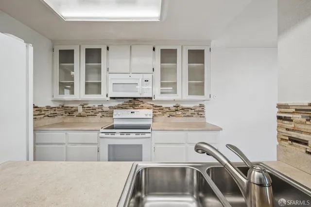 a kitchen with a sink stove and cabinets